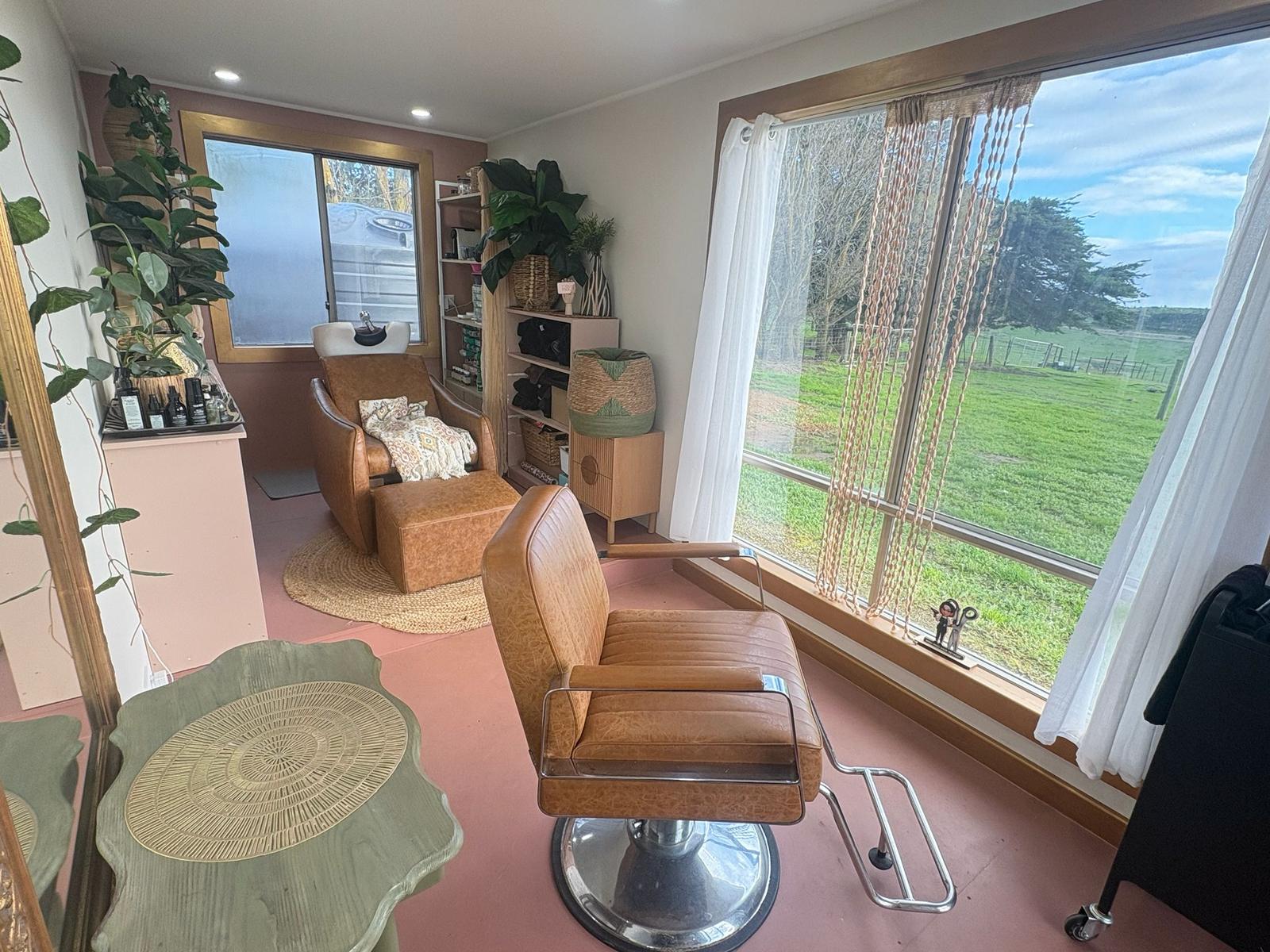 Leather styling chair looking out to the paddocks at Mou Mou Hair Retreat
